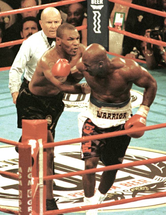 Mike Tyson shoves Evander Holyfield during a timeout called by Mills Lane after Tyson bit Holyfield’s ear in the third round of their 1997 bout at MGM Grand Garden Arena.