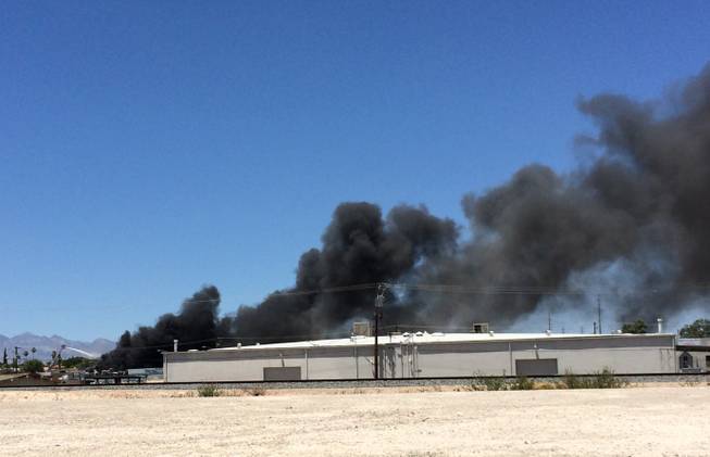Firefighters battle a blaze at a recycling center in North Las Vegas on Tuesday, June 16, 2015.