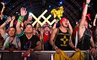 Fans wait as the beat picks up while taking in Arty at the Circuit Grounds during the first night of EDC at the Las Vegas Speedway on Saturday, June 20, 2015.