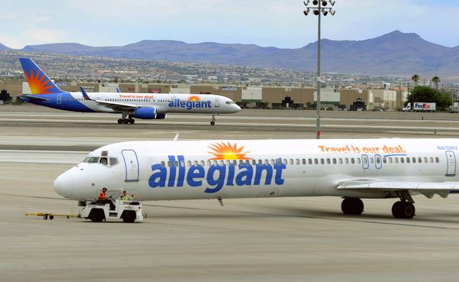 In this Thursday, May 9, 2013, file photo, two Allegiant Air jets taxi at McCarran International Airport in Las Vegas.