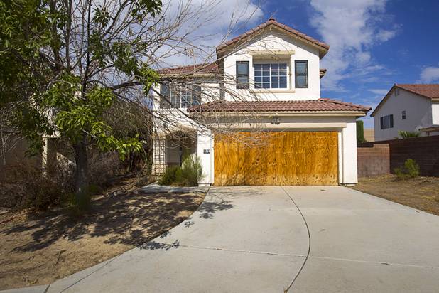 A foreclosed home is shown in a neighborhood near Tenaya Way and Russell Road Thursday, June 25, 2015.