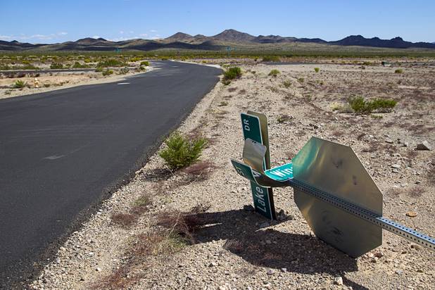 A street sign is shown on the ground in stalled residential Airpark development near the Searchlight Airport in Searchlight on Sunday, Sept. 28, 2014.
