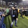In this Monday, Jan. 12, 2015, file photo, Nike Chairman Phil Knight walks near the field before the NCAA football playoff championship game between Ohio State and Oregon in Arlington, Texas. Knight plans to step down and says he wants Nike President and CEO Mark Parker to succeed him. 
