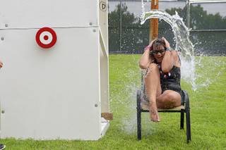 Beth Vandenberg reacts as a bucket of water is dumped on her head during the 67th annual Damboree Celebration in Boulder City, Nev. Saturday, July 4, 2015.