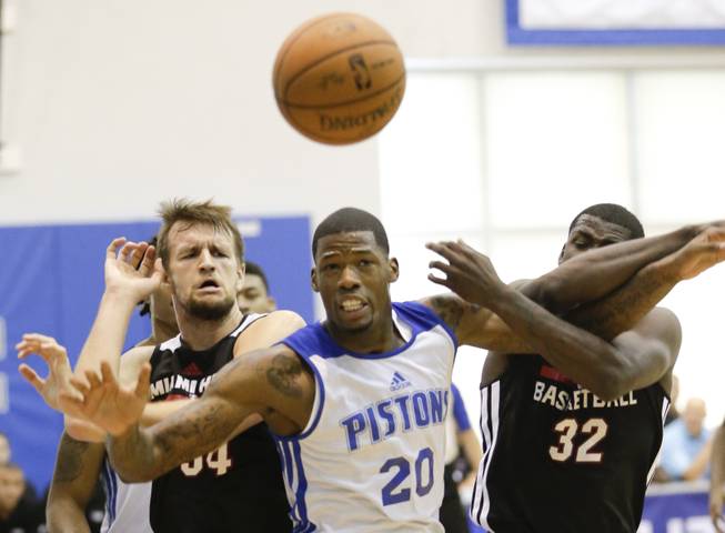 Detroit Pistons' DeAndre Liggins (20) goes after a rebound between Miami Heat's Danilo Barthel, left, and James Ennis (32) during an NBA summer league game Tuesday, July 8, 2014, in Orlando, Fla.