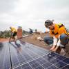 In this file photo, Vivint Solar employees install solar panels on a home.