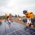 In this file photo, Vivint Solar employees install solar panels on a home.