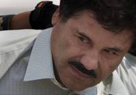 Joaquin "El Chapo" Guzman is escorted Feb. 22, 2014, to a helicopter in handcuffs by Mexican navy marines at a navy hanger in Mexico City. 