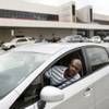 Uber driver Ingemar Smith avoids the curb outside the baggage claim at Atlanta's Hartsfield-Jackson airport because pickups by nonpermitted drivers are barred, May 17, 2015. 