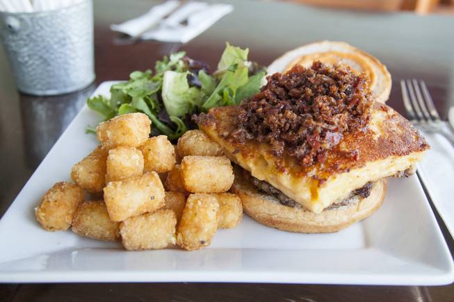 The TNB Signature Burger at Truffles N Bacon Cafe restaurant located in Henderson, NV, includes an angus patty, grilled mac'n'cheese square, and their award winning bacon jam Thursday, July 17, 2015.
