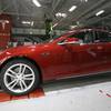 Tesla employees work on Model S cars at the Tesla factory Thursday, May 14, 2015, in Fremont, Calif.