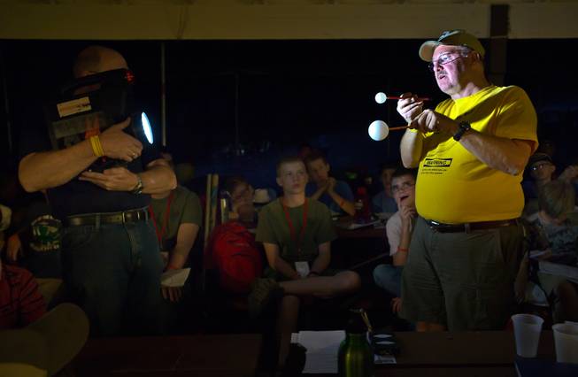 Las Vegas Astronomical Society member Rob Lambert holds the simulated sun as member Julian Shull displays the orbit of the earth and moon to Boy Scouts at their camp on Mt. Potosi on Tuesday, June 23, 2015.