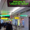 This Jan. 10, 2014, file photo shows passengers as they maneuver through one of the cramped hallways at at New York's LaGuardia Airport. 