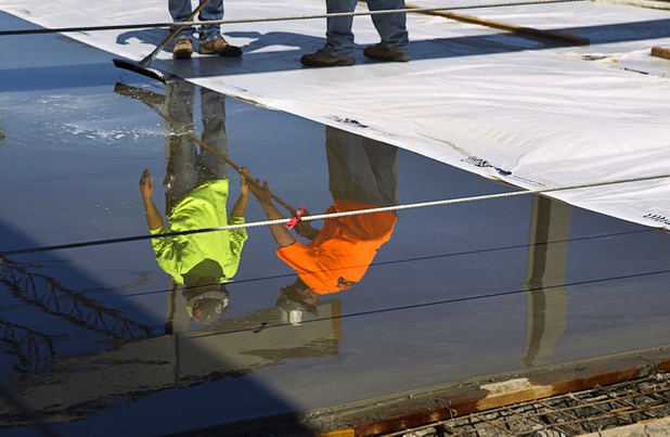 Workers are reflected in water as construction continues on the Ikea Las Vegas store at Durango Drive and Sunset Road Tuesday, July 28, 2015. The store is expected to open in the summer of 2016.