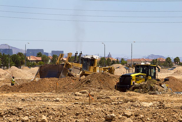Earth-moving equipment prepares the land for development at a DR Horton residential project north of the Ikea Las Vegas construction siteTuesday, July 28, 2015.