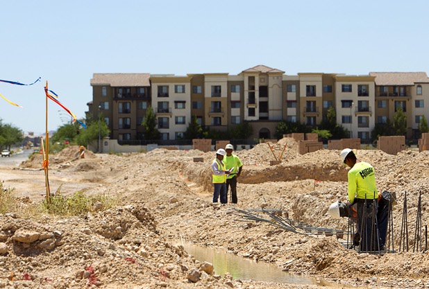 Workers are shown at a residential development at Patrick Lane and Riley Street Tuesday, July 28, 2015.