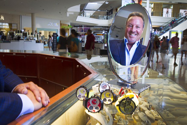 Stuart Berger, owner of Berger & Son Fine Jewelers, is reflected in a mirror in the store at the Fashion Show Mall Monday Aug. 3, 2015.
