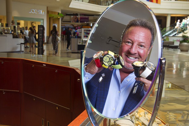 Stuart Berger, owner of Berger & Son Fine Jewelers, is reflected in a mirror in the store at the Fashion Show Mall Monday Aug. 3, 2015.