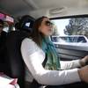 In this Feb. 28, 2014, photo, Lyft driver Brittany Cameron drives her vehicle as she gives a ride to Jennie Morris in Denver. Ride-sharing companies Uber and Lyft are now serving Nevada.