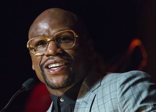 Boxer Floyd Mayweather Jr. smiles at the podium after being announced as fighter of the year during the Nevada Boxing Hall of Fame induction ceremony at Caesars Palace on Saturday, Aug. 8, 2015.