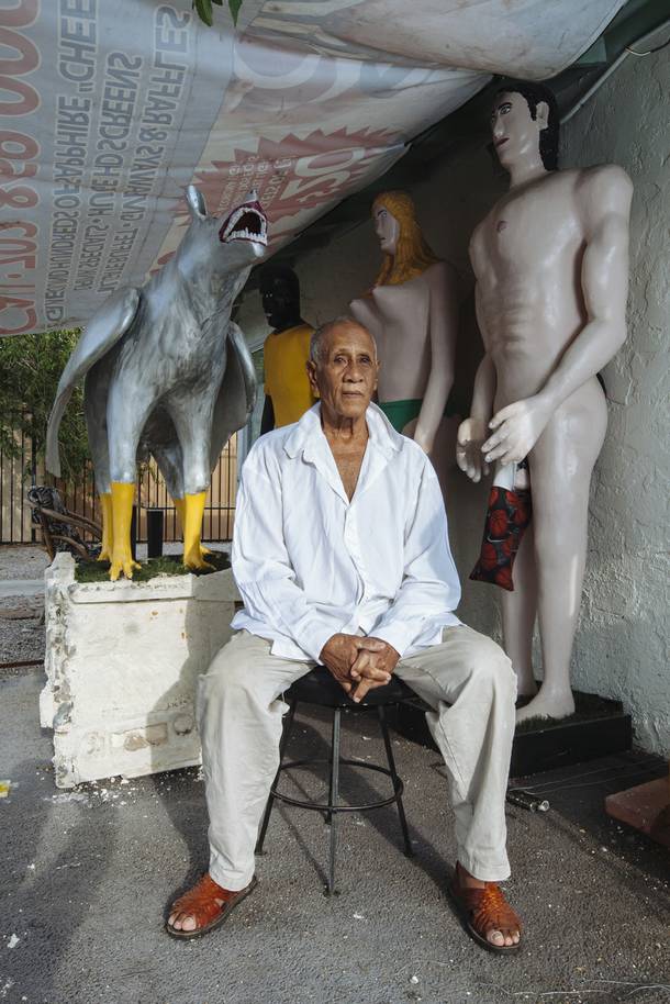 Rafael Espino sits in front of his sculptures on July 30, 2015.