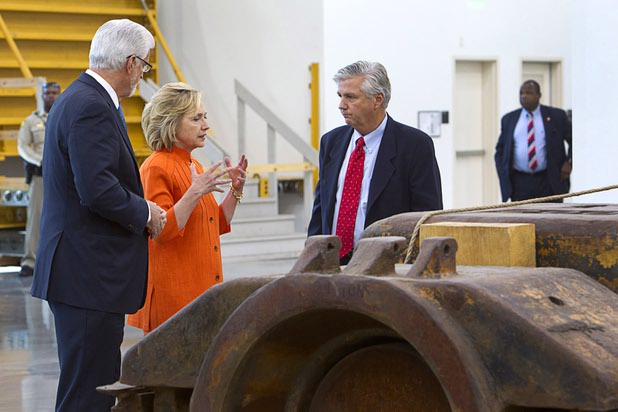 Democratic presidential candidate and former Secretary of State Hillary Rodham Clinton talks with Doug McCarron, left, general president of the United Brotherhood of Carpenters, and Bill Irwin Jr., executive director of the Carpenters International Training Fund, during a tour of the Carpenters International Training Center Tuesday, Aug. 18, 2015.