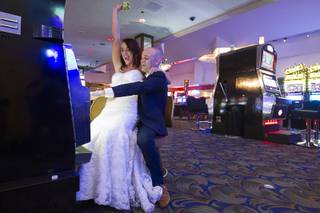 Newlyweds Nicola and Marcus Taylor of Britain pose at a slot machine during the last night of the Las Vegas Club' operation in downtown Las Vegas Wednesday, Aug. 19, 2015. The casino closed it's doors at midnight.