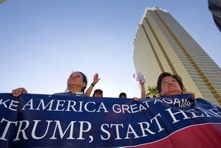 Members of the Culinary Workers Union, Local 226, hold a banner during a Culinary Union protest near the Trump International Hotel Las Vegas Friday, Aug. 21, 2015. The Trump International Hotel workers are not unionized. 