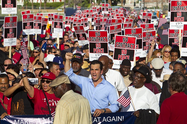 Geoconda Arguello-Kline, left, secretary-treasurer for Culinary Workers Union, Local 226, and Nevada State Sen. Ruben Kihuen, center, a Democratic candidate for U.S. Congress, take part in a Culinary Union protest near Trump International Hotel on Friday, Aug. 21, 2015, in Las Vegas. Trump International Hotel workers are not unionized.