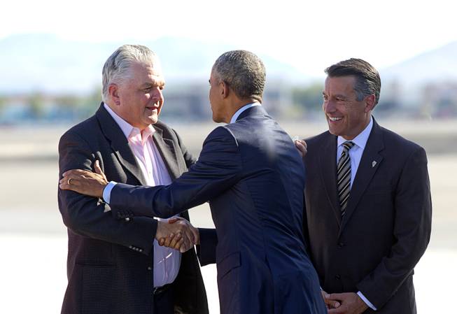Clark County Commission Chairman Steve Sisolak, left, and Governor Brian Sandoval welcome at McCarran International Airport Monday, Aug. 24, 2015. Obama delivered the keynote address at the National Clean Energy Summit 8.0 in the Mandalay Bay Convention Center.