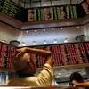 People watch trading boards at a private stock market gallery in Kuala Lumpur, Malaysia on Monday, Aug. 24, 2015. Stocks tumbled across Asia on Monday as investors shaken by the sell-off last week on Wall Street unloaded shares in practically every sector.