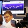 A trader watches his screens when the curve of the German stock index DAX went up close to 10,000 points again at the stock market in Frankfurt, Germany, Tuesday, Aug. 25, 2015. 