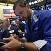 Traders Fred DeMarco, left, and Kevin Lodewick, right, work on the floor of the New York Stock Exchange, Tuesday, Aug. 25, 2015. U.S. stocks jumped at the open after China's central bank cut interest rates to support its economy.