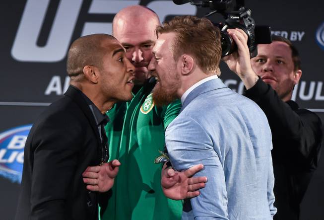 UFC featherweight champion Jose Aldo faces off against title challenger Conor McGregor on Wednesday, Aug. 26, 2015, as UFC President Dana White tries to separate them during a UFC fan event at the Convention Center in Dublin, Ireland.