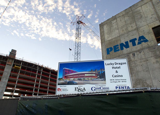 A sign showing an artist's illustration of the Lucky Dragon Hotel & Casino is posted at the casino's construction site,300 W. Sahara Ave., Sunday, Aug. 30, 2015.