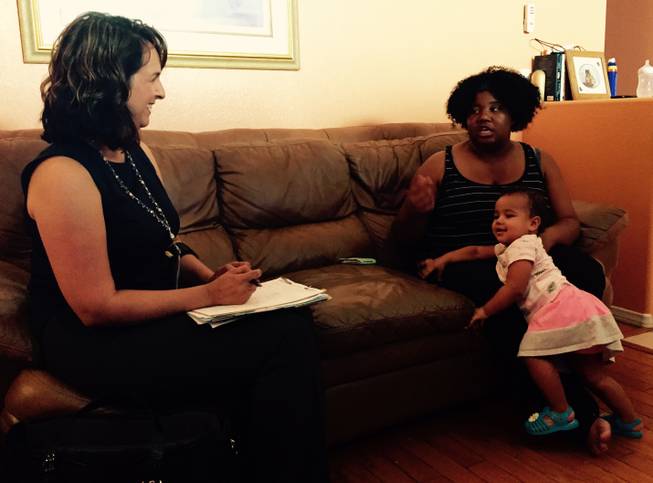 Deyanira Goss, a community health nurse with the Southern Nevada Health District, talks to Kortney Colon and her 18-month-old daughter, Kamree, on Wednesday, Aug. 26, 2015. Colon is enrolled in the Nurse-Family Partnership Program.