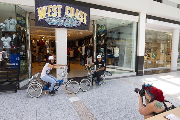 Valeria Torres and Leonel DeRosas pose for photographer Jess W. during a photoshoot in front of West Coast Street Wear at the Boulevard Mall Sunday, Sept. 6, 2015.