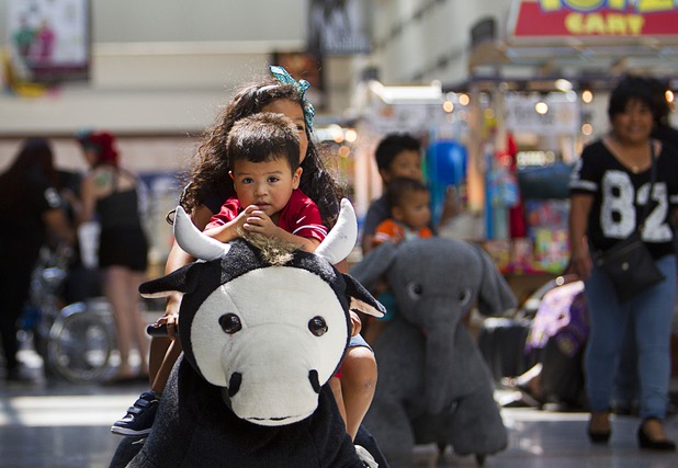 Jose Gonzalez, 2, rides a mechanical animal with his sister Melina, 7, at the Boulevard Mall Sunday, Sept. 6, 2015.