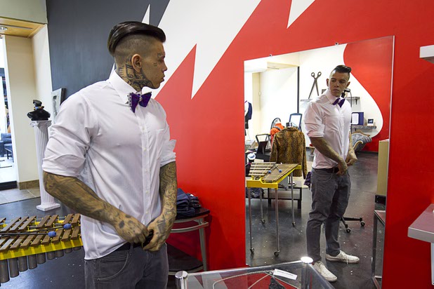 Model Quest Gulliford, tucks in his shirt during a photoshoot at Dapper Industries Cut & Sew, a boutique menswear store, in the Boulevard Mall Sunday, Sept. 6, 2015.