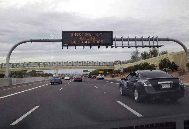 A freeway sign asked for information on Wednesday, Sept. 9, 2015, about a shooting that shattered a rear window of a white truck on I-10 between 43rd Ave. and 35th Ave. in Phoenix.