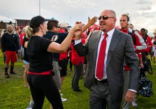 UNLV head coach Tony Sanchez gives a high five as he and his team arrive to the cheering of fans for their game versus UCLA at Sam Boyd Stadium on Saturday, September 12, 2015.