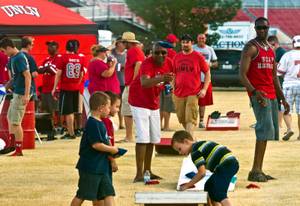 Tailgaters play some corn hole and party a bit before the game as UNLV faces UCLA at Sam Boyd Stadium on Saturday, September 12, 2015.
