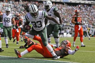 New York Jets running back Chris Ivory (33) runs over Cleveland Browns' Chris Kirksey for a touchdown during the first half of an NFL football game Sunday, Sept. 13, 2015, in East Rutherford, N.J.