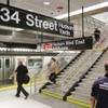 Travelers walks downstairs to the No. 7 subway line at the 34th Street and 11th Avenue station, New York City's first new station in a quarter-century, Sunday, Sept. 13, 2015. The station links Times Square to a booming neighborhood on Manhattan's far West Side at 34th Street.