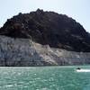In this July 17, 2014, photo, recreational boaters ride by a bathtub ring that delineates the high water mark at Lake Mead.