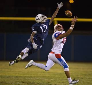 Liberty's Nayton Koki, 43, reaches out for a long pass defended well by Centennial's J.J. Johnson, 12, during their high school football game on Friday, September 18, 2015.
