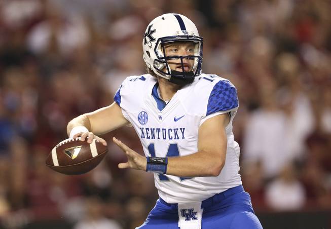 Kentucky Wildcats quarterback Patrick Towles (14) looks for an open receiver in the first half of an NCAA college football game against South Carolina Saturday, Sept. 12, 2015, in Columbia, S.C.