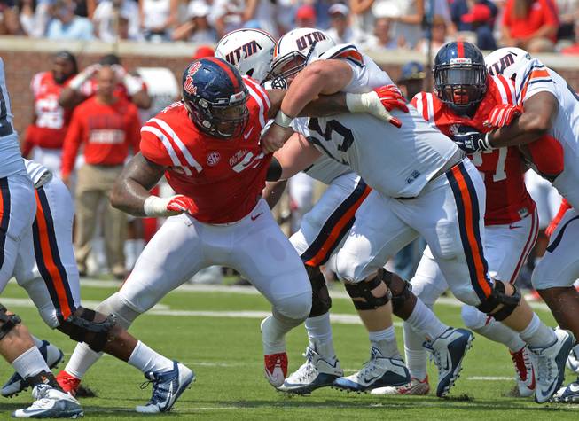Mississippi defensive tackle Robert Nkemdiche (5) fights past Tennessee-Martin offensive lineman Jordan Murphy (75) during the first quarter of an NCAA college football game in Oxford, Miss., Saturday, Sept. 5, 2015