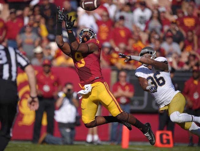 Southern California wide receiver JuJu Smith (9) makes a catch in the end zone as Notre Dame cornerback Cole Luke defends during the first half of an NCAA college football game, Saturday, Nov. 29, 2014, in Los Angeles. The play was called back because Smith did not maintain possession of the ball as he went out of bounds.