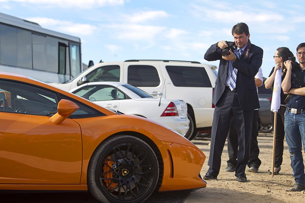 Erik Pappa, Clark County director of public communications, takes a photo of a Lamborghini Gallardo LP550 during a ground breaking ceremony for Speed Vegas, a $30 million, 90-acre racetrack project on Las Vegas Boulevard south of the M Resort, Monday, Sept. 21, 2015. The project is expected to open in early 2016.